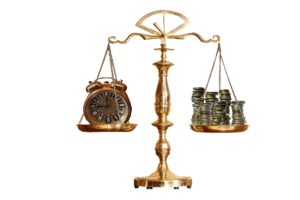 Scales of justice with a clock on one side and money on the other showing the balancing of considerations in hiring a manifestation determination attorney